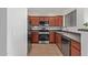 Modern condo kitchen with stainless steel appliances and dark wood cabinets at 1941 S Pierpont Dr # 2098, Mesa, AZ 85206