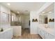 Bright bathroom featuring a glass enclosed shower, dual sinks, and wood-look tile flooring at 20802 N Grayhawk Dr # 1087, Scottsdale, AZ 85255