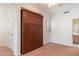 A bright bedroom featuring carpet flooring, built-in wardrobe, and an ensuite bath at 20802 N Grayhawk Dr # 1087, Scottsdale, AZ 85255