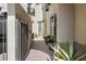 Charming outdoor entryway featuring wrought iron fencing, potted plants, and stylish architectural details at 20802 N Grayhawk Dr # 1087, Scottsdale, AZ 85255