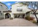 Exterior view of a home with an attached two-car garage and desert landscaping at 20802 N Grayhawk Dr # 1087, Scottsdale, AZ 85255