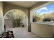 Covered patio with an arched doorway leading to the backyard at 20802 N Grayhawk Dr # 1087, Scottsdale, AZ 85255