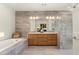 Modern bathroom with double vanity, soaking tub, and walk-in shower at 21609 N 159Th Ln, Sun City West, AZ 85375