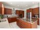 Modern kitchen with granite island, stainless steel appliances, and rich wood cabinetry at 21609 N 159Th Ln, Sun City West, AZ 85375