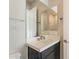 Bathroom with dark vanity, quartz countertop, and modern fixtures at 21951 E Misty Ln, Queen Creek, AZ 85142