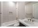 Bathroom with white tile, bathtub, and quartz countertop at 21951 E Misty Ln, Queen Creek, AZ 85142