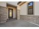 Elegant entryway with modern door and brick accents at 21951 E Misty Ln, Queen Creek, AZ 85142