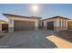 Modern two-car garage with gray doors and brick facade at 21951 E Misty Ln, Queen Creek, AZ 85142