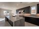 Modern kitchen with large island, stainless steel appliances, and dark cabinetry at 21951 E Misty Ln, Queen Creek, AZ 85142