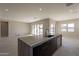 Modern kitchen island with dark cabinetry and large sink at 21951 E Misty Ln, Queen Creek, AZ 85142