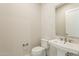 Modern powder room featuring stylish tile and a pedestal sink at 21951 E Misty Ln, Queen Creek, AZ 85142