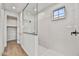 Modern bathroom featuring a glass shower and walk-in closet at 31381 N 130Th Ave, Peoria, AZ 85383