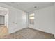 Spacious bedroom with neutral carpeting and double door closet at 31381 N 130Th Ave, Peoria, AZ 85383