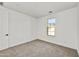 Bright and airy bedroom with neutral carpeting and large window at 31381 N 130Th Ave, Peoria, AZ 85383