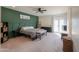 King-size bedroom with green accent wall and access to backyard at 4053 E Glencove St, Mesa, AZ 85205