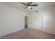 Well-lit bedroom with ceiling fan and double door closet at 4053 E Glencove St, Mesa, AZ 85205