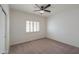 Spacious bedroom featuring a ceiling fan and window shutters at 4053 E Glencove St, Mesa, AZ 85205