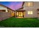 Landscaped backyard with covered patio at dusk at 41 E Caroline Ln, Tempe, AZ 85284