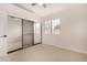 Well-lit bedroom with mirrored closet doors at 41 E Caroline Ln, Tempe, AZ 85284