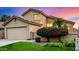 Two-story house with tan exterior, attached garage, and nicely landscaped yard at 41 E Caroline Ln, Tempe, AZ 85284