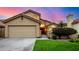 Tan stucco two-story house with a two-car garage and well-manicured lawn at 41 E Caroline Ln, Tempe, AZ 85284