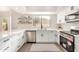 Modern white kitchen with stainless steel appliances and quartz countertops at 41 E Caroline Ln, Tempe, AZ 85284