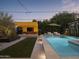 Inviting backyard oasis with a sparkling pool and fire pit at 61 W Wilshire Dr, Phoenix, AZ 85003