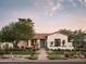 Charming Spanish-style home with a terracotta roof, teal door and well-manicured lawn at 61 W Wilshire Dr, Phoenix, AZ 85003