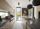 Modern kitchen with marble countertops and a breakfast bar at 61 W Wilshire Dr, Phoenix, AZ 85003