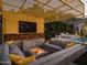 Relaxing patio area with fire pit, built-in seating, and TV at 61 W Wilshire Dr, Phoenix, AZ 85003