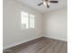 Simple bedroom with wood-look floors and a window at 619 E Jensen St # 55, Mesa, AZ 85203