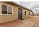 Tan stucco house with a dark-grey front door and small patio at 619 E Jensen St # 55, Mesa, AZ 85203