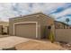 Attached garage with tan door and ample driveway parking at 619 E Jensen St # 55, Mesa, AZ 85203