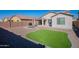 Backyard with patio, artificial grass and a grill at 7067 W Maya Way, Peoria, AZ 85383