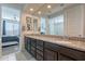 Double vanity bathroom with granite countertop and view into bedroom at 7067 W Maya Way, Peoria, AZ 85383