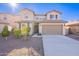 Two-story house with a two-car garage and landscaped front yard at 7067 W Maya Way, Peoria, AZ 85383