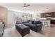 Open living room with grey sofas, a coffee table, and wood-look floors at 7067 W Maya Way, Peoria, AZ 85383