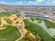 Aerial view of a golf course with clubhouse and surrounding area at 7710 E Monica Dr, Scottsdale, AZ 85255