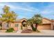 Front view of a tan house with palm trees and drought-resistant landscaping at 7710 E Monica Dr, Scottsdale, AZ 85255