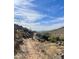 Dusty desert trail with cacti and vegetation in a sunny, mountainous setting. Arizona living at 7710 E Monica Dr, Scottsdale, AZ 85255