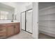 Bathroom with walk-in shower and wood cabinets at 9242 E Sector Dr, Mesa, AZ 85212