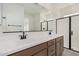 Double vanity bathroom with a large mirror and shower at 9242 E Sector Dr, Mesa, AZ 85212