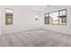 Spacious bedroom with neutral carpet and multiple windows at 9242 E Sector Dr, Mesa, AZ 85212