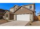 Two-story house with a white garage door and brown accents at 9242 E Sector Dr, Mesa, AZ 85212