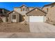 Two-story house with a white garage door and brown accents at 9242 E Sector Dr, Mesa, AZ 85212