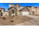 Two-story house with a white garage door and brown accents at 9242 E Sector Dr, Mesa, AZ 85212