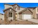 Two-story house with a white garage door and brown accents at 9242 E Sector Dr, Mesa, AZ 85212