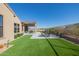 Landscaped backyard with artificial turf and a patio area at 13271 E Desert Vista Rd, Scottsdale, AZ 85255