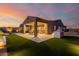 Stunning backyard at dusk showcasing a covered patio and outdoor kitchen at 13271 E Desert Vista Rd, Scottsdale, AZ 85255
