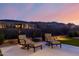 Evening view of backyard with patio furniture and artificial turf at 13271 E Desert Vista Rd, Scottsdale, AZ 85255